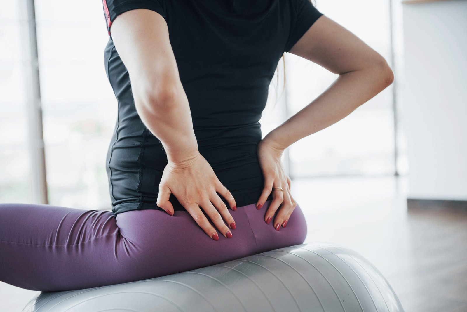 Young pregnant women sitting on the ball for exercises in the gym.